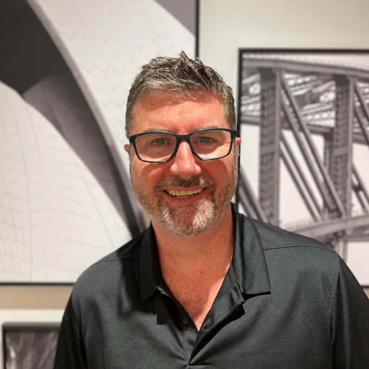 Campbell Travis, creator of FORGE, wearing a plain black polo shirt.